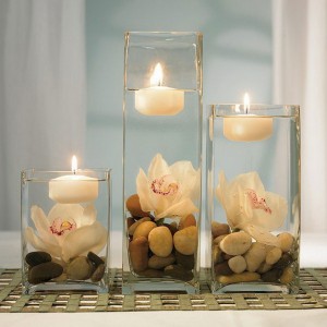 Floating candles with orchids and river rocks